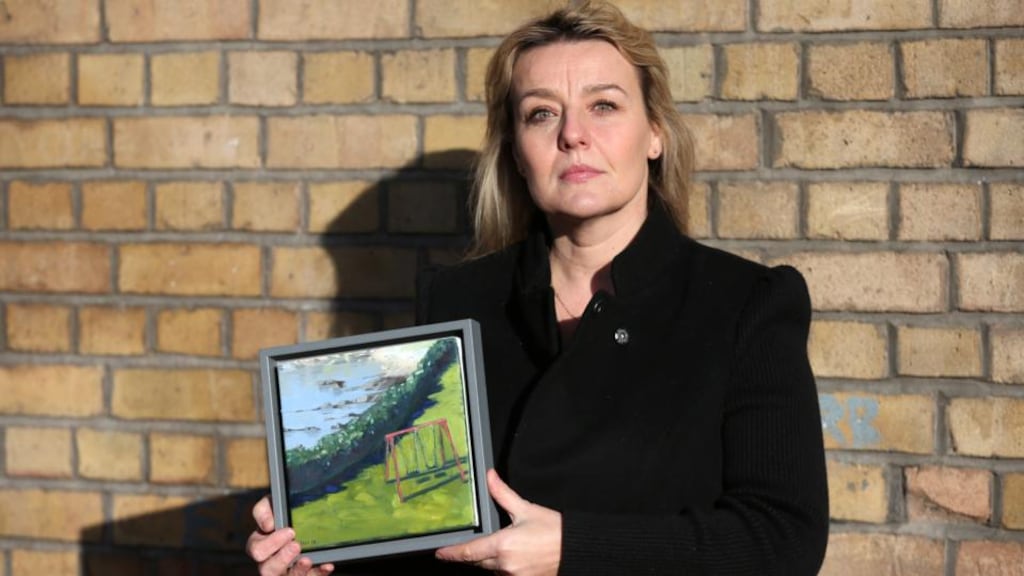 Hugg: Fiona Twomey with a painting donated by Una Sealy for Saturday’s art sale at St Andrew’s Resource Centre on Pearse Street, Dublin 2. Photograph: Laura Hutton