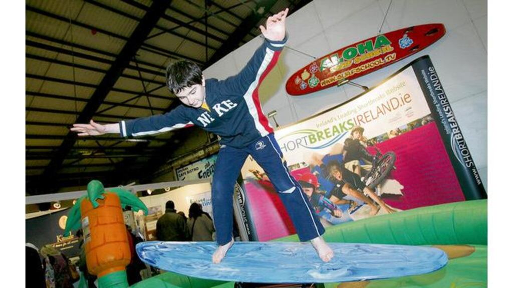 Cian Byrne from Shankill tries surfing yesterday at a 'Short Breaks Ireland' stand at the annual Holiday World Show in the RDS.