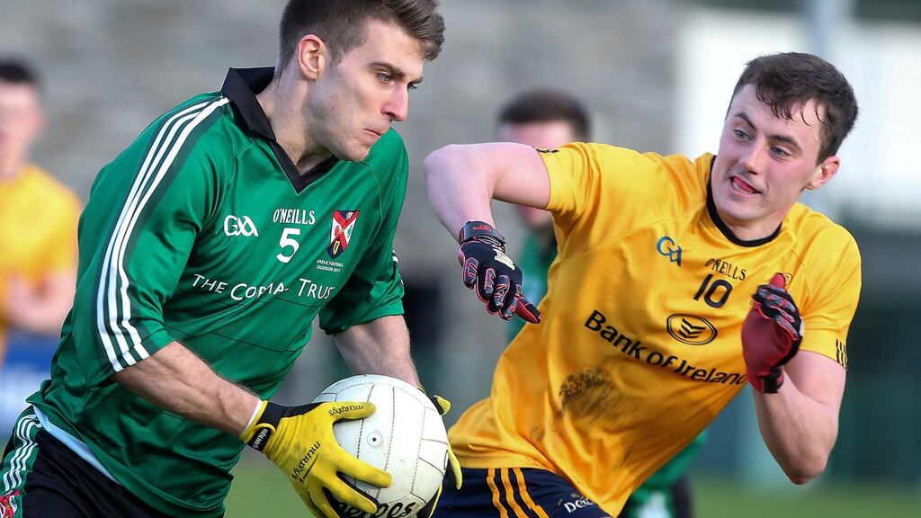 Queen’s University’s Shea Heffron in action against Hugh McFadden of DCU during DCU’s  3-10 to 0-3 win in Belfast. Photograph: Jonathan Porter/Press Eye/Inpho