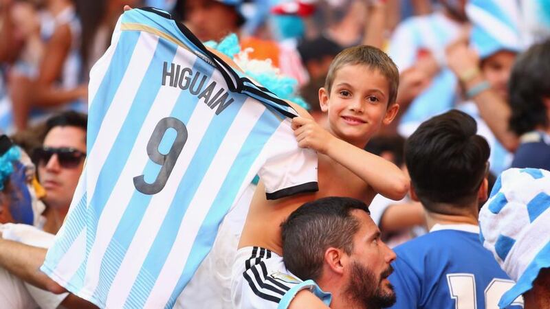 An Argentina fan holds up a Gonzalo Higuain shirt during the quarter-finalagainst Belgium at Estadio Nacional . Photograph: Julian Finney/Getty Images