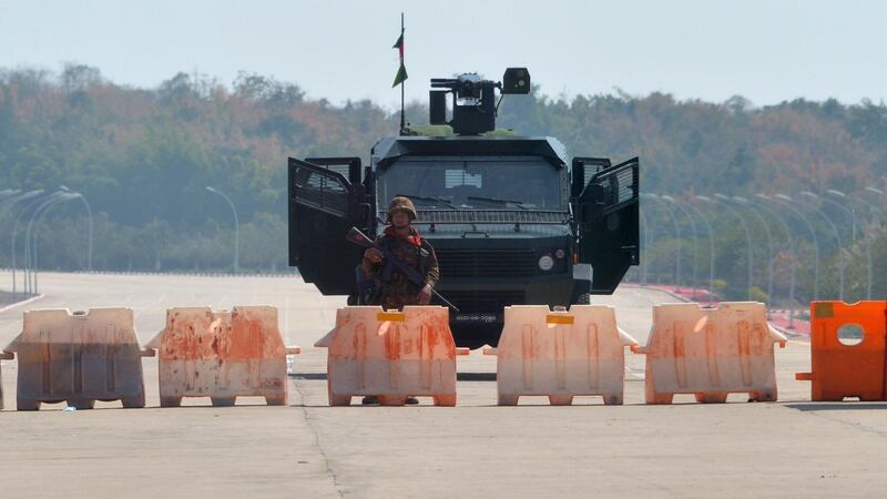 A soldier stands guard on a blockaded road to Myanmar’s parliament after the military detained the country’s de facto leader Aung San Suu Kyi and the country’s president in a coup. Photograph: STR/AFP/Getty Images.