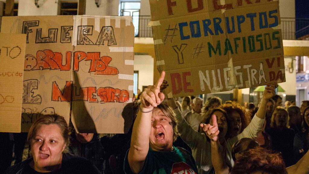 People shout slogans against corruption during a protest outside Madrid in 2014. Photograph: Sergio Perez/Reuters