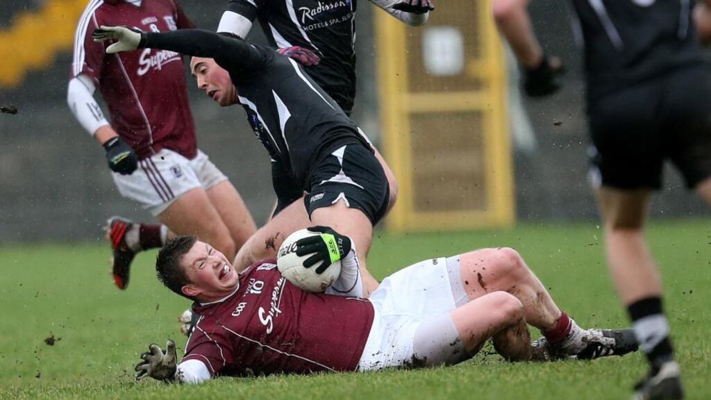 Galway’s Gareth Bradshaw holds possession despite the attentions of Neil Ewing of Sligo during the Connacht FBD Football League round one game in Tuam. Photograph: James Crosbie/Inpho.