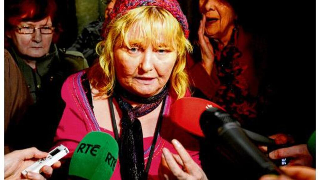 Mary Smyth speaks to media outside the Dáil after the apology from Enda Kenny. photograph: alan betson