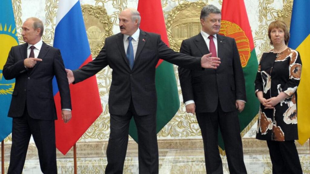 Russian president Vladimir Putin gestures next to Belarussian president Alexander Lukashenko, Ukrainian president Petro Poroshenko, and EU high representative for foreign affairs and security policy Catherine Ashton as they line up for a group photo prior the start of the meeting in Minsk, Belarus, today. Photograph: EPA