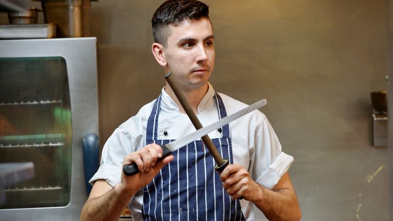 Harry Quinn, junior sous chef, sharpening his knife