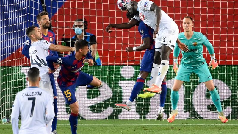 Napoli’s Kalidou Koulibaly leaps to head the ball during his side’s defeat to Barcelona. Photograph: Lluis Gene/Getty/AFP