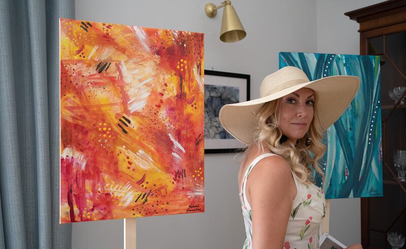 Natalie Forrester with one of her paintings