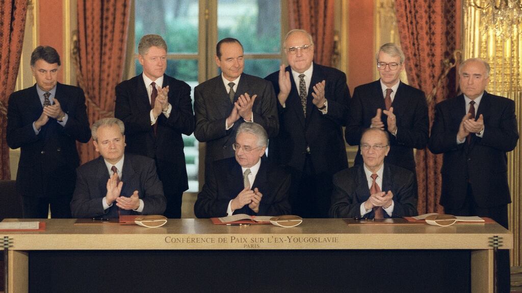The leaders of Serbia, Bosnia and Croatia sign  the peace agreement on Bosnia in  December 1995 whilst world leaders look on. Photo: Getty.