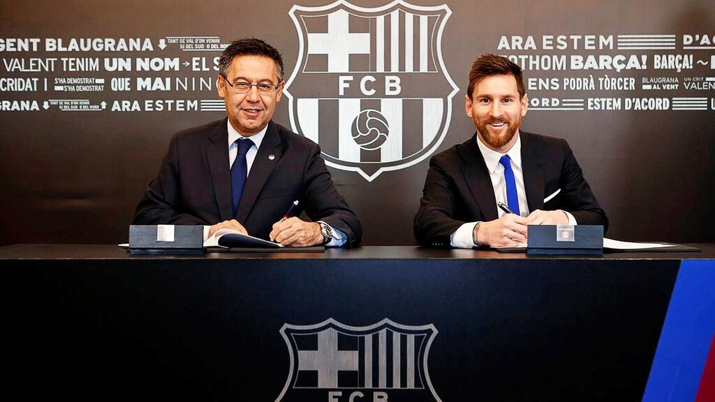 Lionel Messi signs his new Barcelona contract alongside club president Josep Maria Bartomeu. Photograph: David Saura/EPA