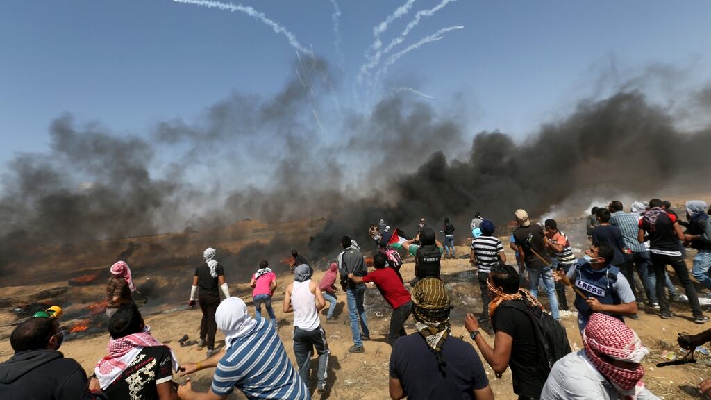 Tear gas canisters are fired by Israeli forces at Palestinian demonstrators during a protest demanding the right of return, at the Israel-Gaza border in the southern Gaza Strip, on Friday. Photograph: Ibraheem Abu Mustafa/Reuters