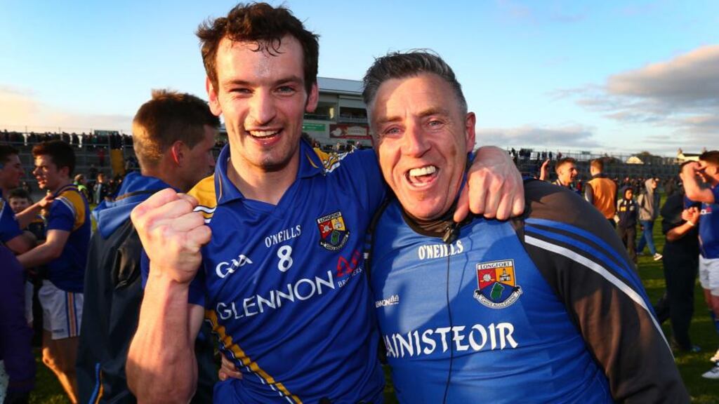 Longford’s Barry Gilleran and manager Jack Sheedy celebrate the championship victory over Offaly at Tullamore. Photograph: Cathal Noonan/Inpho