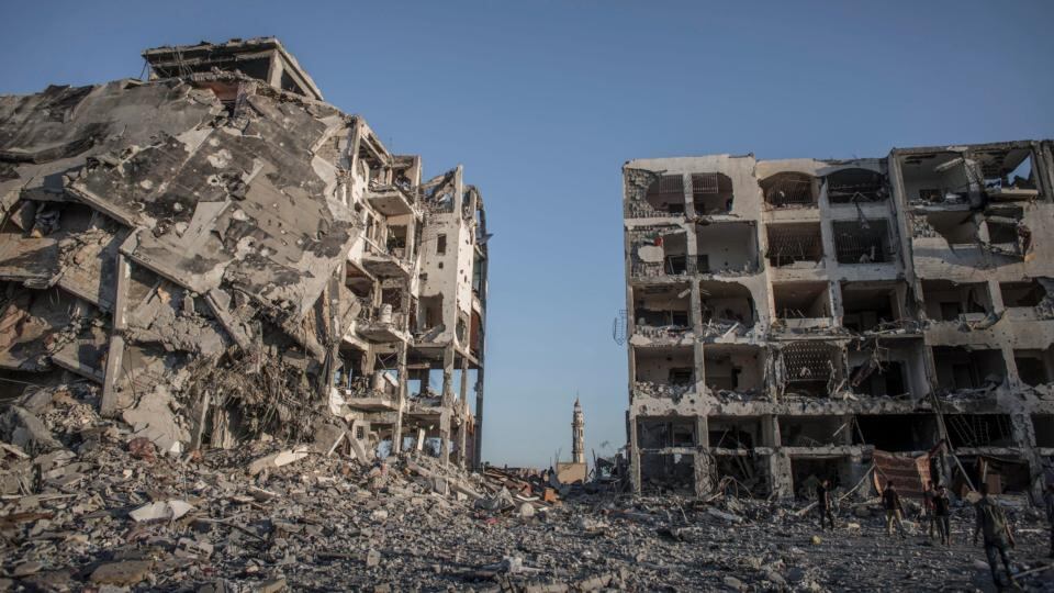 The minaret of a mosque stand between apartment complexes, destroyed by Israeli forces, in Beit Lahia, northern Gaza. Photograph: Oliver Weiken/EPA