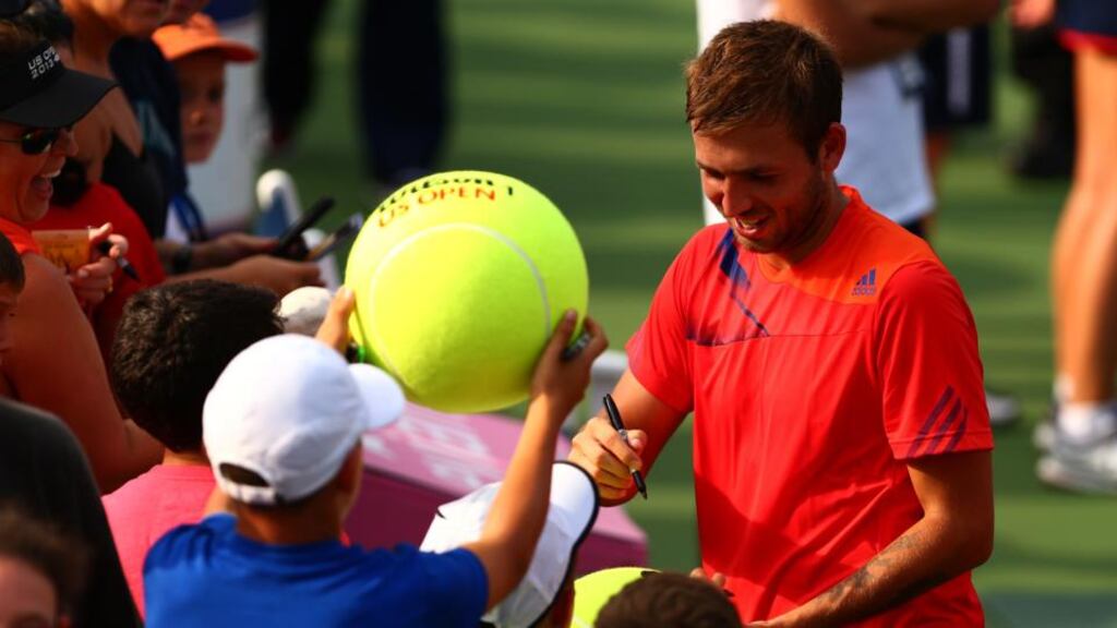 Dan Evans of Great Britain signs autographs for fans after winning his men’s singles second round match against Bernard Tomic of Australia at USTA Billie Jean King National Tennis Centre in New York. Photograph: Dan Istitene/Getty Images