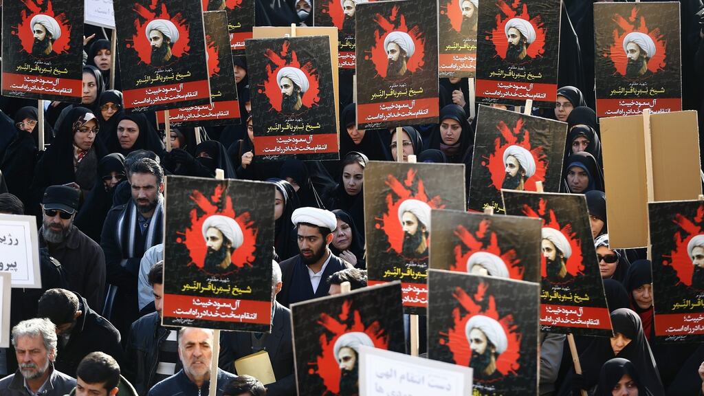 Iranians hold aloft posters of Shia cleric Nimr al-Nimr during an anti-Saudi Arabia demonstration at the Imam Hossein square in Tehran. Photograph: EPA