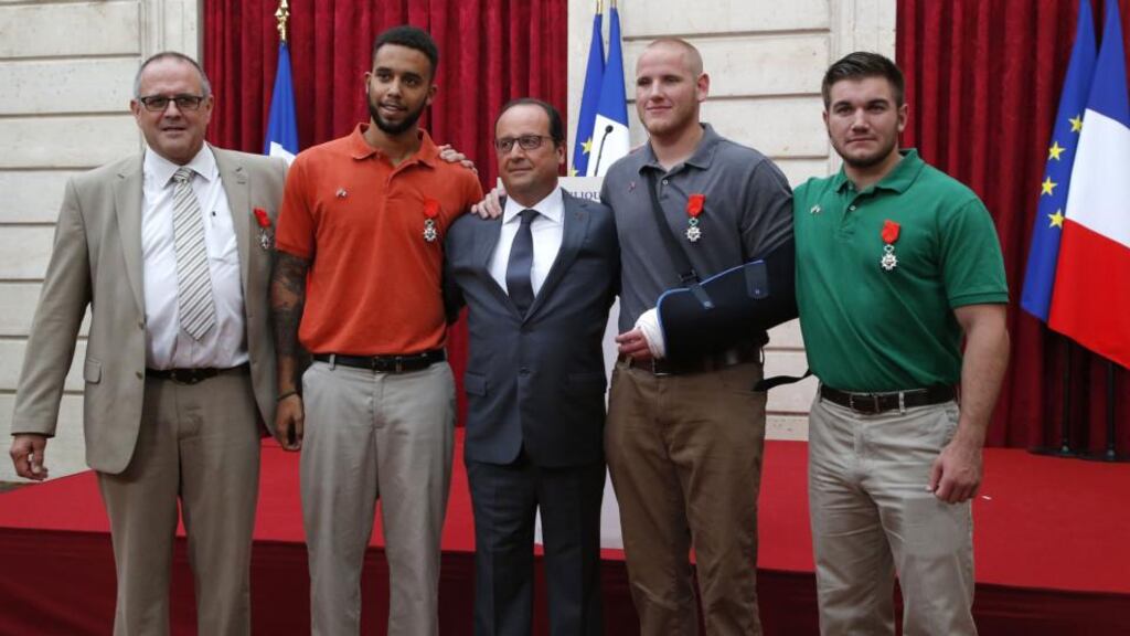 French President François Hollande (centre) with Briton Chris Norman and Americans Anthony Sadler, Spencer Stone and Alek Skarlatos at the Élysée Palace in Paris yesterday. Photograph: Michel Euler/AFP/Getty Images