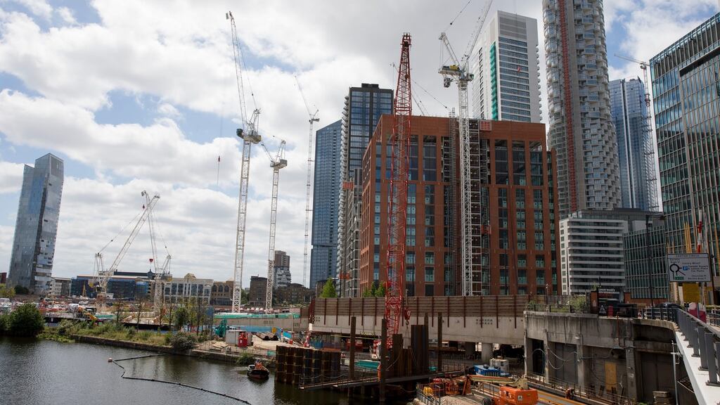 Builders work at  Wood Wharf, London:  UK government pledges to “Build back better, build back greener, build back faster”.  Photograph: Jason Alden/Bloomberg
