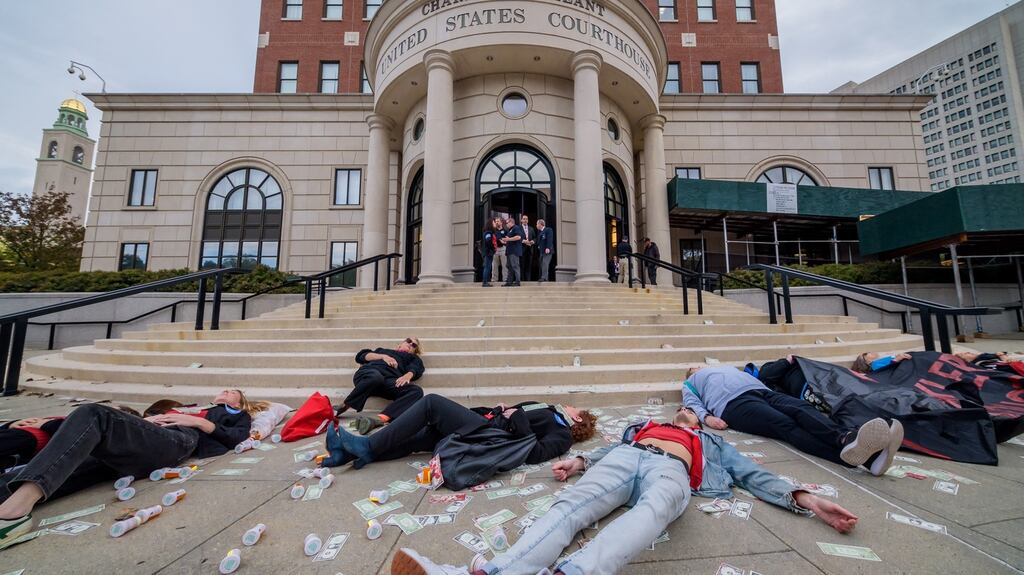 Protesters staging a die-in outside the courthouse, where a Purdue Pharmaceuticals bankruptcy hearing was being held. Photograph: Erik McGregor/ LightRocket via Getty
