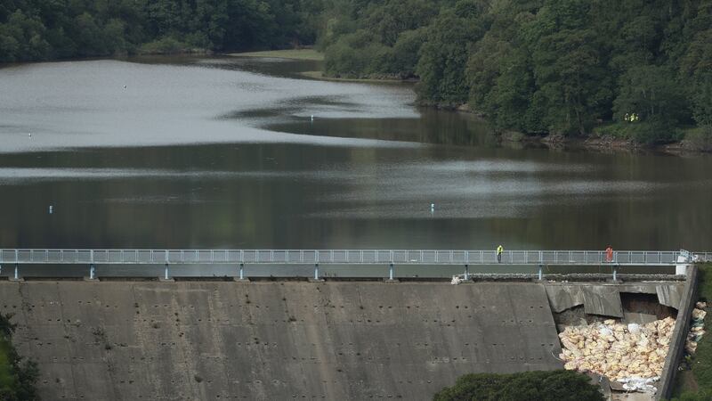 Workers make repairs to Toddbrook Reservoir near the village of Whaley Bridge in Derbyshire, after it was damaged in heavy rainfall. Photograph: Yui Mok/PA Wire