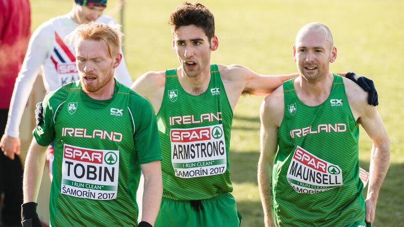 Ireland’s Sean Tobin, Hugh Armstrong and Kevin Maunsell celebrate their fifth-place finish in the European Cross Country team event. Photograph: Sasa Pahic Szabo/Inpho
