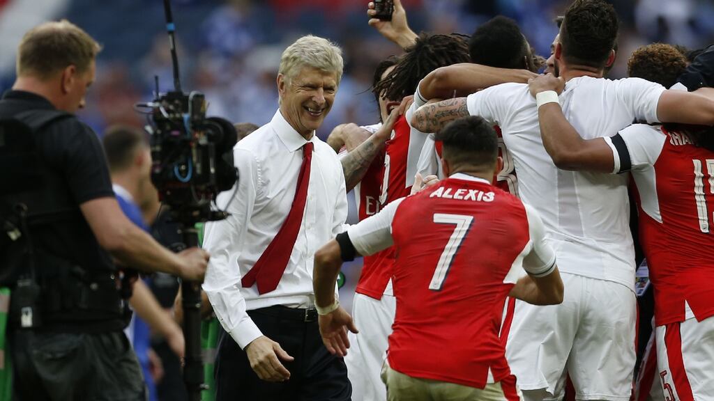Arsène Wenger celebrates with the players on the pitch after Arsenal’s FA Cup final win against Chelsea at Wembley stadium. Arsenal won the game 2-1. Photograph: Ian Kington/AFP/Getty Images
