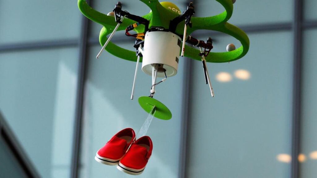 A custom-built drone developed for Crocs Japan GK carries a pair of Crocs Norlin sneakers while flying during a media preview at the company’s temporary “aerial store” in Tokyo . Photographer: Kiyoshi Ota/Bloomberg