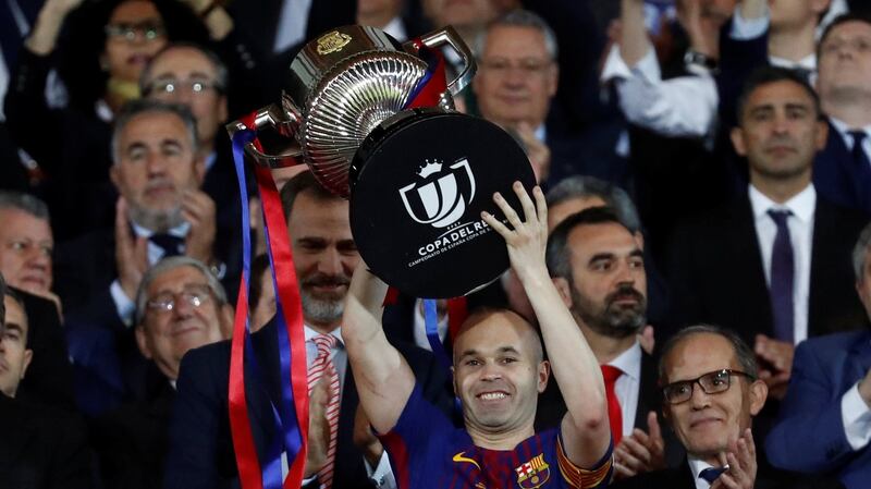 Barcelona captain Andres Iniesta lifts the trophy King Felipe VI applauds. Photograph: Juan Medina/Reuters