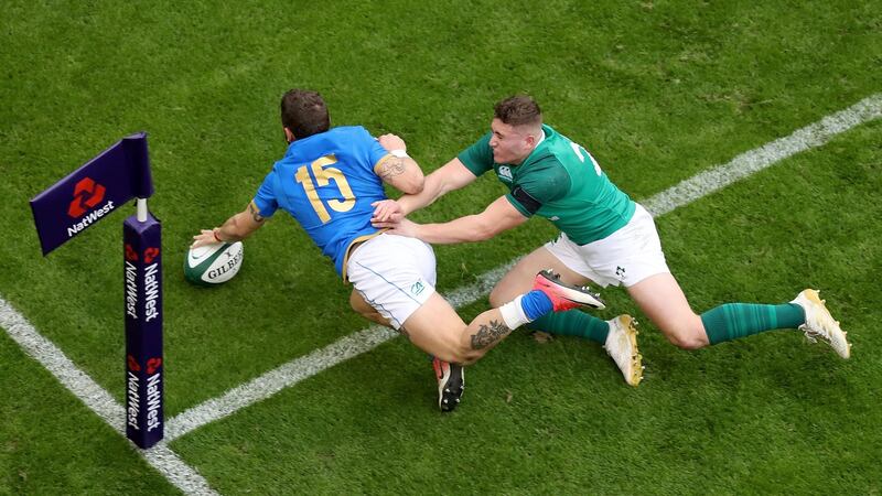 Matteo Minozzi scores ahead of Jordan Larmous. Photograph: Tommy Dickson/Inpho