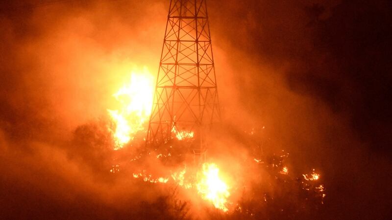 Fires burn around power line towers in Coyote Canyon near Montecito. Photograph: Reuters