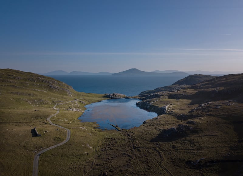 An aerial view of Inishturk Island’s freshwater lake with the Tale of the Tongs sculpture in the background. Photograph: Michael McLaughlin