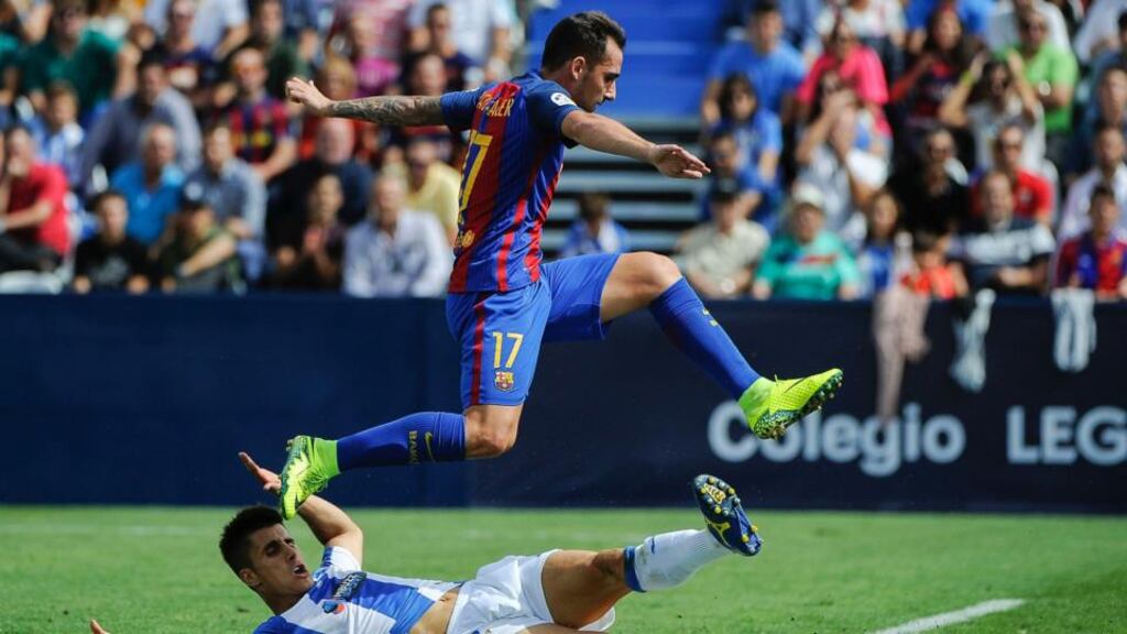 Barcelona’s forward Paco Alcacer jumps over Leganes’ defender Victor Diaz during the La Liga clash at the Butarque municipal stadium in Leganes. Photo: Getty Images