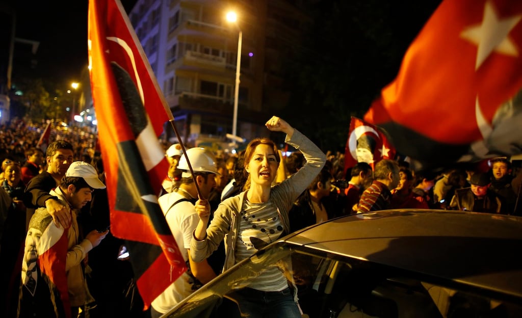 Anti-government protesters shout slogans and wave Turkey’s national flags during a demonstration in central Ankara. Photograph: Umit Bektas/Reuters.