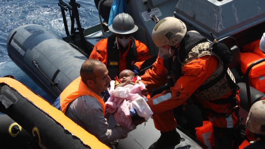 A migrant is carried  aboard the Germany navy’s frigate ‘Hessen’ earlier this month,  before being brought to the port of Palermo, Sicily. EPA/GERMANY NAVY