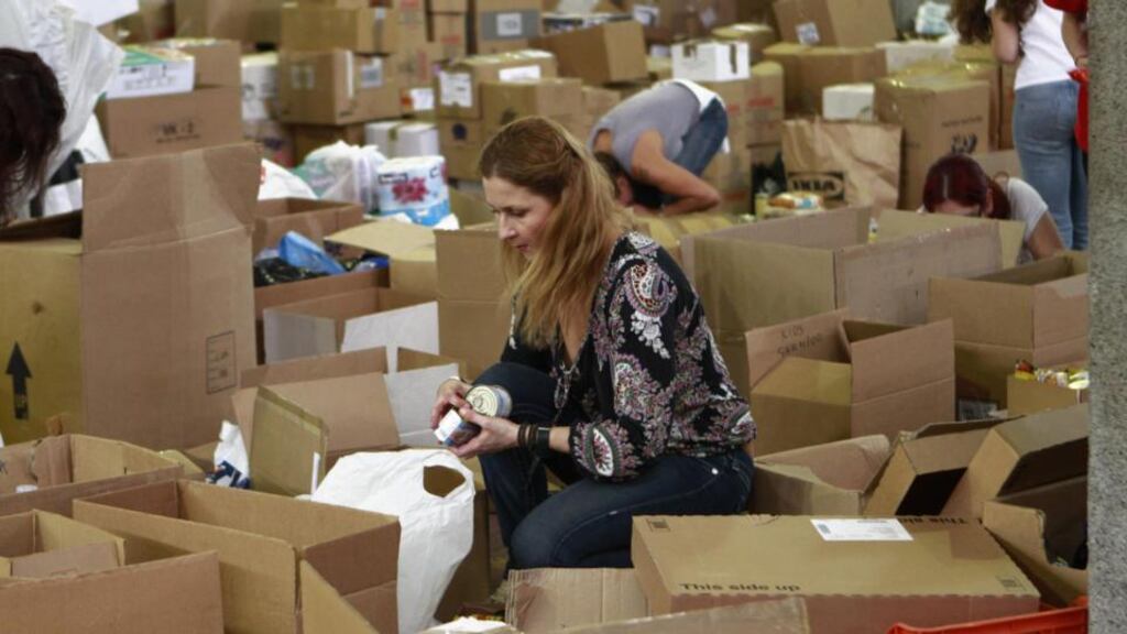 Volunteers sort canned food and other non-perishable items and place them in boxes in the Cypriot capital Nicosia yesterday. Thousands of Cypriots donated the food that will go to needy families who are facing their worst financial crisis in decades. Photograph/Petros Karadjias