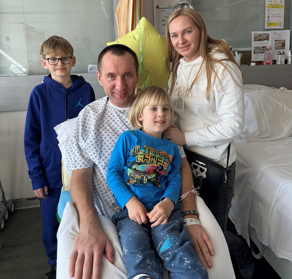 Mykola and Olena Polishchuk with their children Mykola jnr and Vladlien, after the car crash that left the former Ukrainian soldier paralysed.
