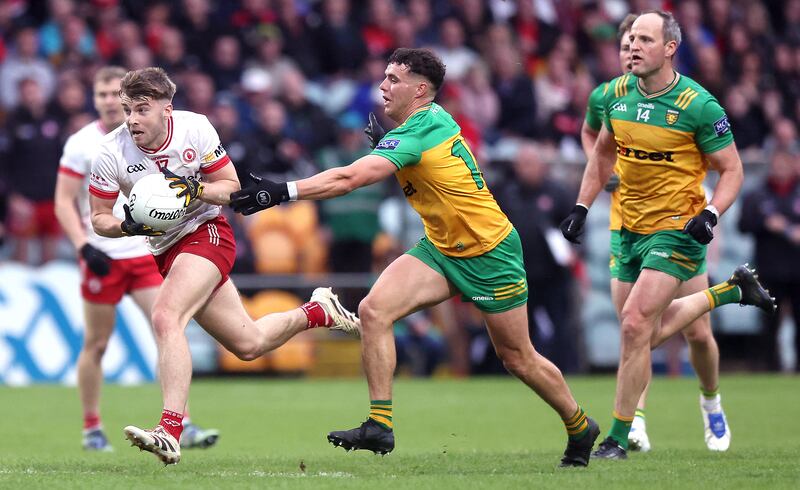 Tyrone's Cormac Quinn evades a challenge from Donegal's Odhran McFadden Ferry to score the last point of the game. Photograph: John McVitty/Inpho