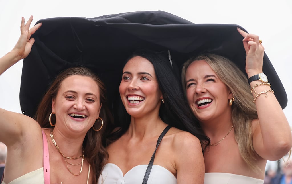 Nicole Brennan, Ciara Walsh and Caragh Hehir from Galway in search of a winner and shelter. Photograph: Tom Maher/Inpho