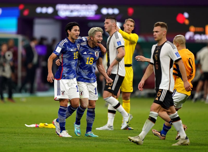 Japan's Takumi Minamino and Takuma Asano celebrate victory over Germany. Photograph: Mike Egerton/PA Wire