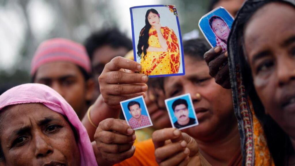 Relatives show pictures of garment workers who are missing, during a protest over the collapse of the Rana Plaza building, in Savar, outside Dhaka. Photograph: Andrew Biraj/Reuters
