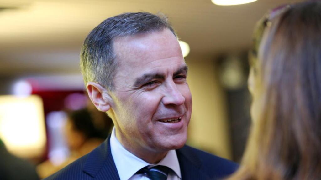Mark Carney, governor of the Bank of England, speaks with a delegate during a break in sessions on the opening day of the World Economic Forum in Davos, Switzerland