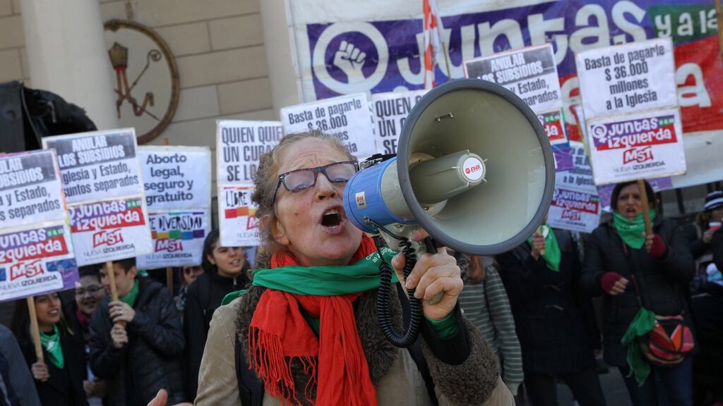 Protesters with green handkerchiefs, emblem of the fight for the legalisation of abortion in Argentina, seek the separation of church and the state, in Buenos Aires. Photograph: Maria Paulina Rodriguez