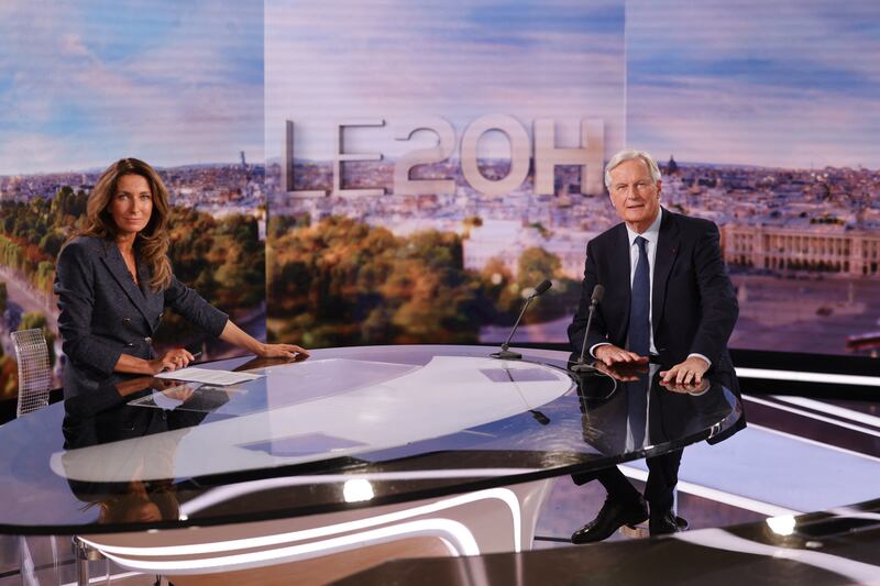 France's newly appointed Prime Minister, Michel Barnier (R) poses during the evening news broadcast of French TV channel TF1 with French journalist and TV host Anne-Claire Coudray in Boulogne-Billancourt Photograph: Getty Images
