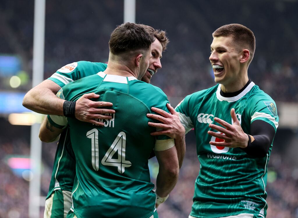 Ireland's Hugo Keenan, Calvin Nash and Sam Prendergast celebrate a try against Scotland. Photograph: Dan Sheridan/Inpho