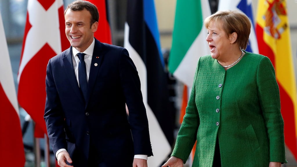 French president Emmanuel Macron and Germany’s chancellor Angela Merkel: “We have made clear in our coalition agreement that we are ready to provide more money for the EU budget,” says Dr Merkel. Photograph: Francois Lenoir/Reuters