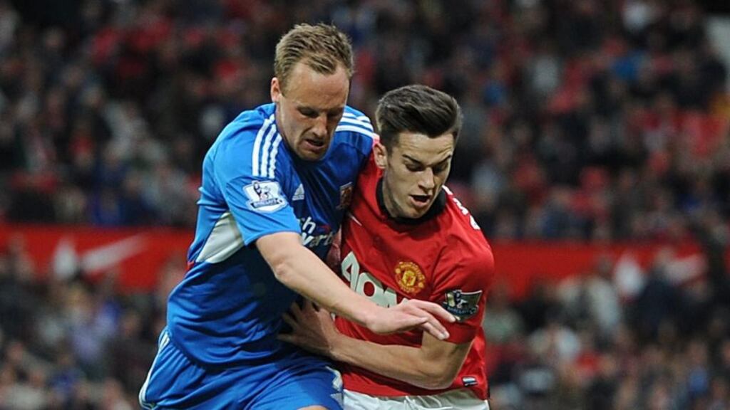 Manchester United’s Tom Lawrence (right) and Hull City’s Republic of Ireland international David Meyler battle for the ball. Photograph: Martin Rickett/PA