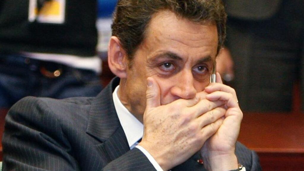 The then French president Nicolas Sarkozy makes a phone call at a European Union leaders’ summit in Brussels in December 2009. Mr Sarkozy’s phone was tapped during a judicial investigation into the financing of his 2007 election campaign, Le Monde newspaper reported today, a move denounced by his lawyer as “monstrous”. Photograph: Reuters/Yves Herman