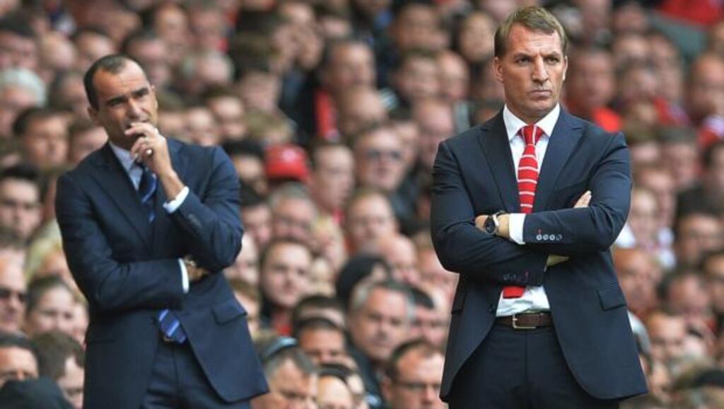 Everton manager Roberto Martinez (left) and Liverpool manager Brendan Rodgers on the sideline at Anfield. Photograph: Peter Powell / EPA