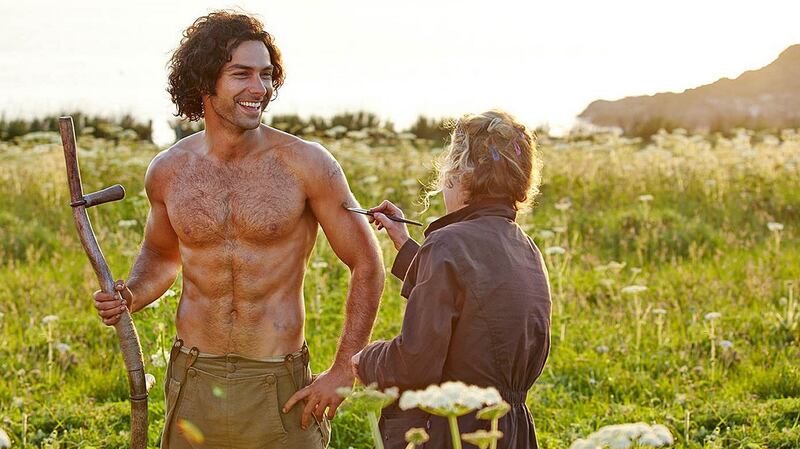 ‘Poldark’ star Aidan Turner gets brushed up by one of the crew in a behind-the-scenes publicity shot for the drama. Photograph: BBC