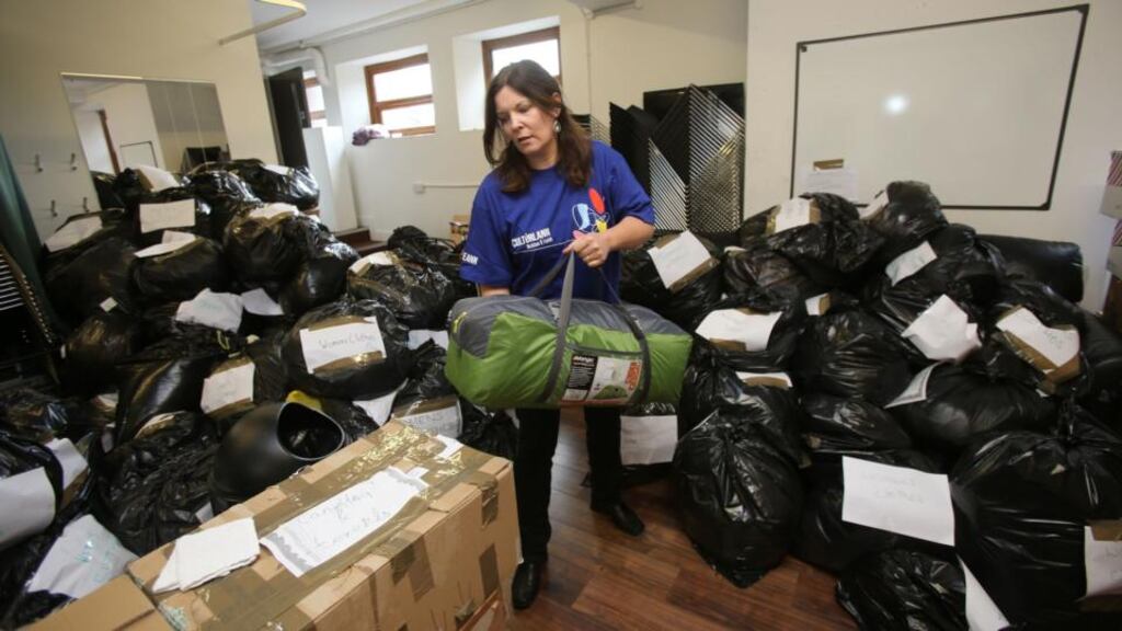 Eimear Ni Mhathuna director of the Culturlann in Belfast with donations to be sent to migrant camps in Calais and the Greek Island of Kos collected by the Northern Ireland Calais Refugee Solidarity group. Photograph: Niall Carson/PA Wire