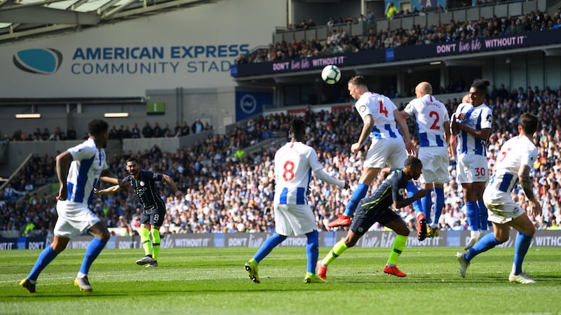 Ilkay Gundogan curls in Manchester City’s fourth against Brighton. Photograph: Michael Regan/Getty
